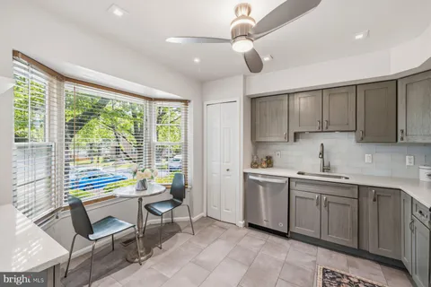a kitchen with a sink dining table and chairs