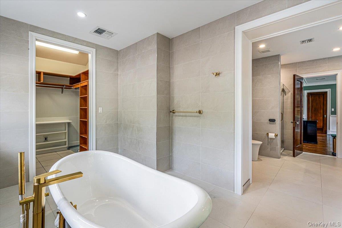 952 Cedar Swamp Road Glen Head, NY 11545 - Photo 25 of 50 a bathroom with a bathtub and a sink
