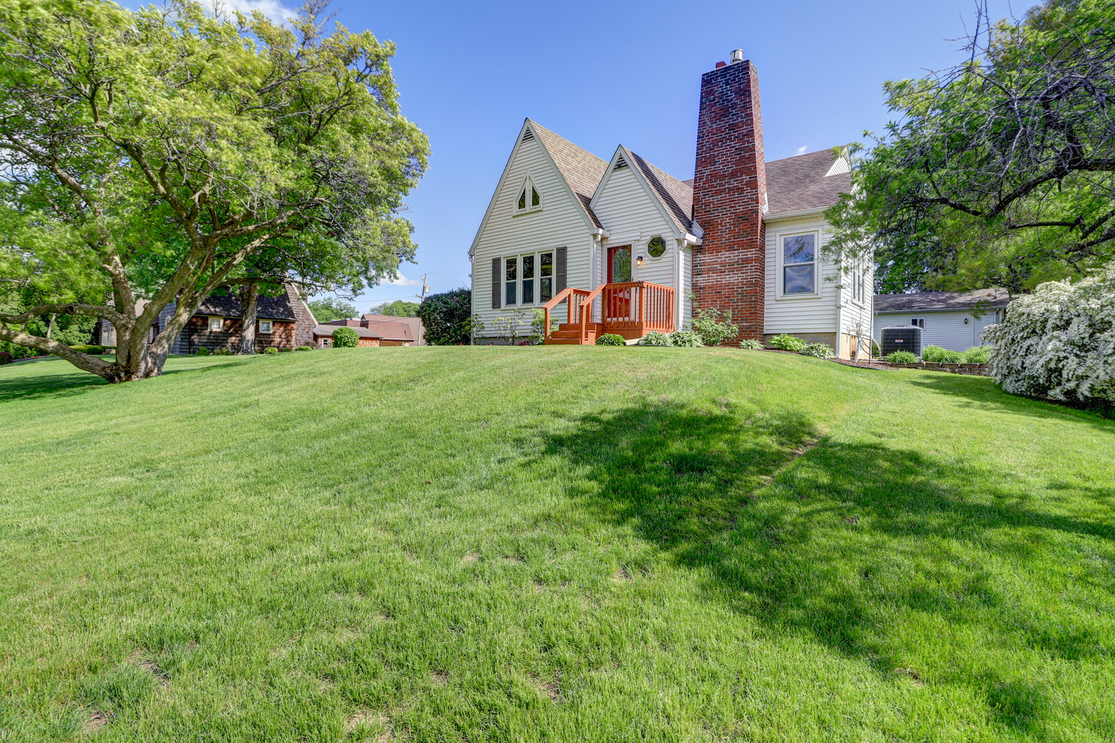 313 West 2nd Street Prophetstown, IL 61277 - Photo 20 of 22 a view of a white house next to a big yard and large trees