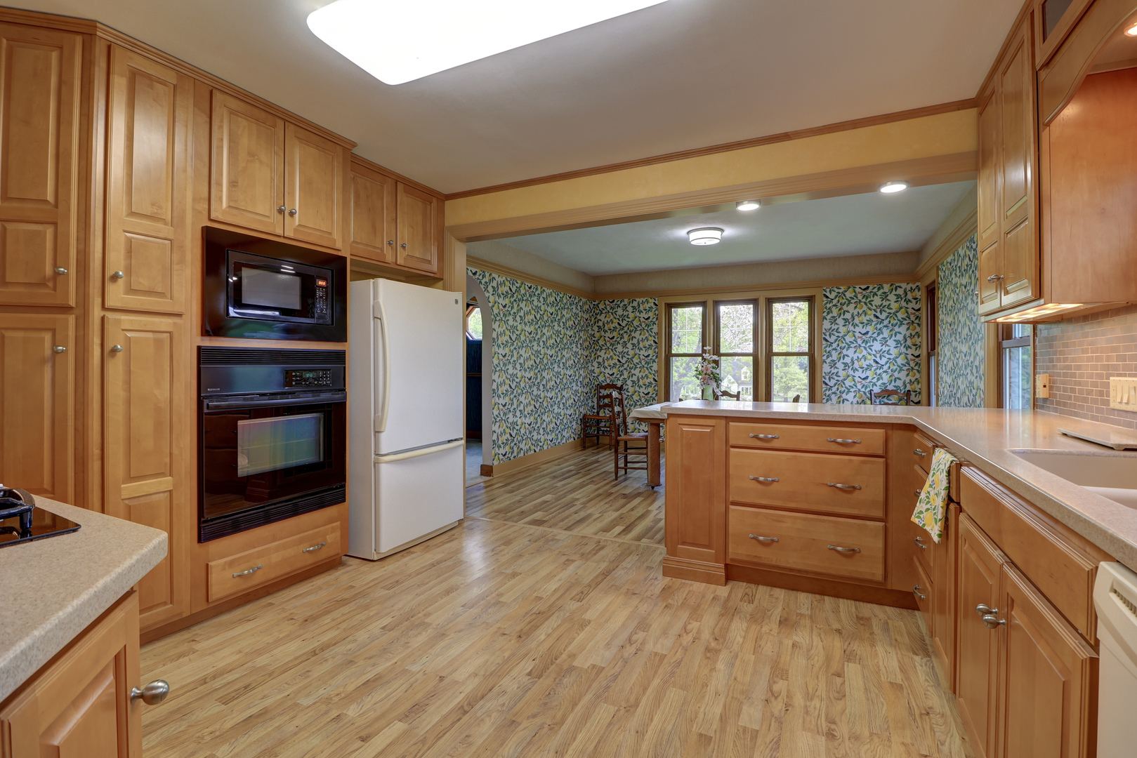 313 West 2nd Street Prophetstown, IL 61277 - Photo 4 of 22 a kitchen with wooden floors and wooden cabinets