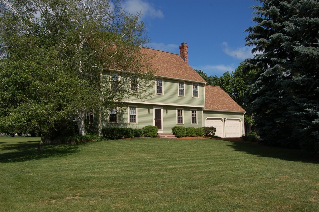 6 Schofield Road Hopkinton, MA 01748 - Photo 1 of 30 a view of a white house next to a yard with plants and trees