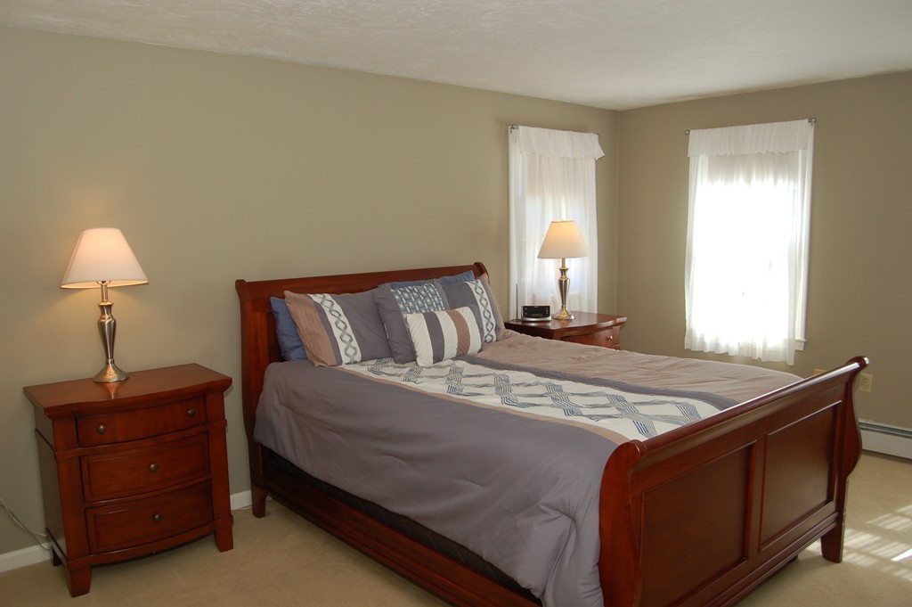 6 Schofield Road Hopkinton, MA 01748 - Photo 13 of 30 a bed sitting in a bedroom next to a window