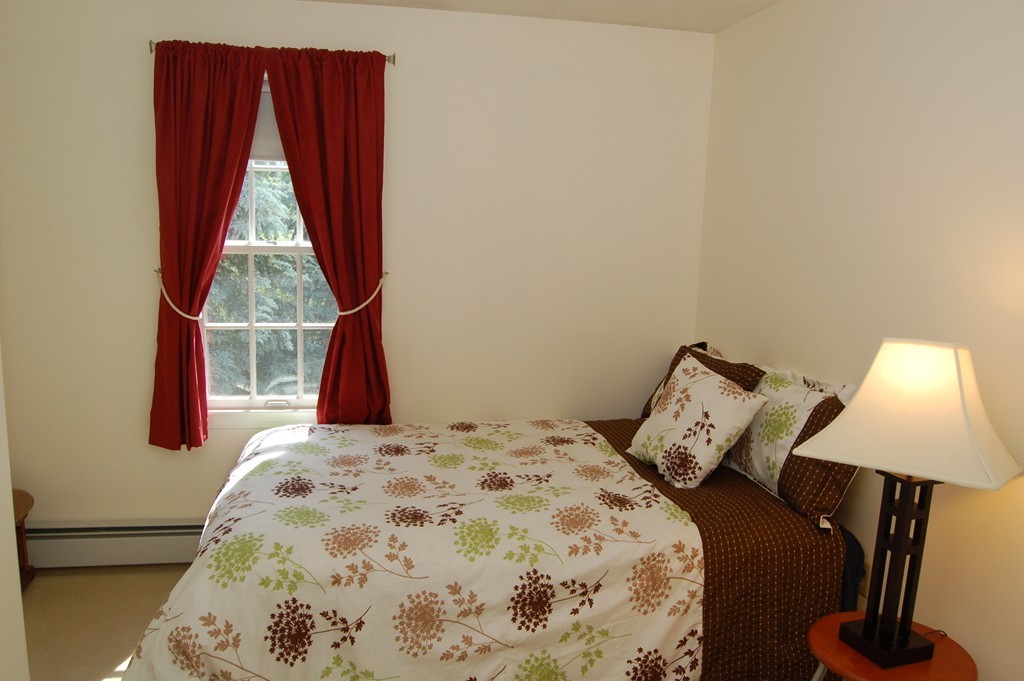 6 Schofield Road Hopkinton, MA 01748 - Photo 18 of 30 a bed sitting in a bedroom next to a window