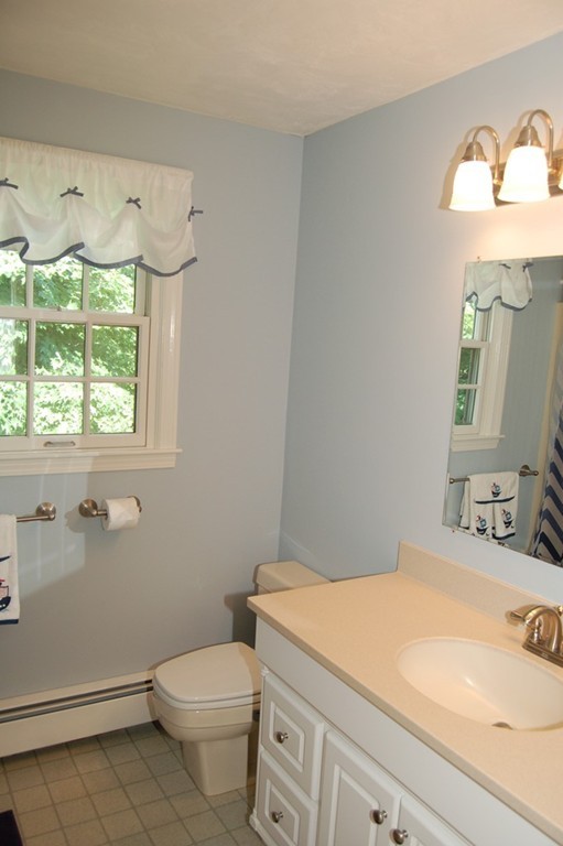 6 Schofield Road Hopkinton, MA 01748 - Photo 19 of 30 a bathroom with a sink a toilet and a mirror