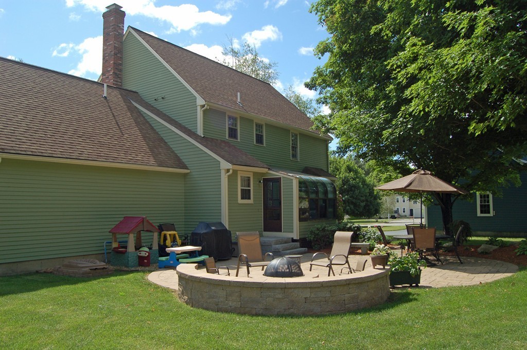 6 Schofield Road Hopkinton, MA 01748 - Photo 27 of 30 a front view of house with yard and outdoor seating