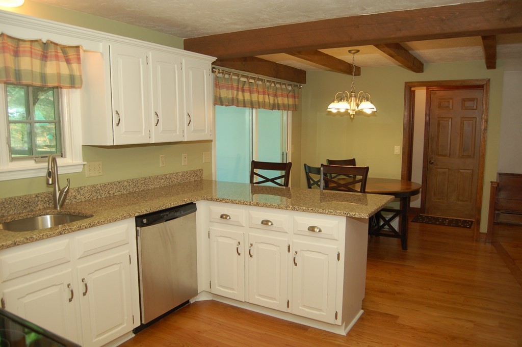 6 Schofield Road Hopkinton, MA 01748 - Photo 4 of 30 a kitchen with granite countertop a sink cabinets and wooden floor
