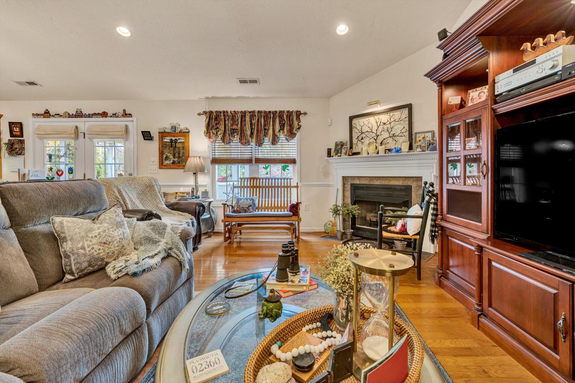 4316 Cove Road Roanoke, VA 24017 - Photo 6 of 31 a living room with furniture a flat screen tv and a fireplace