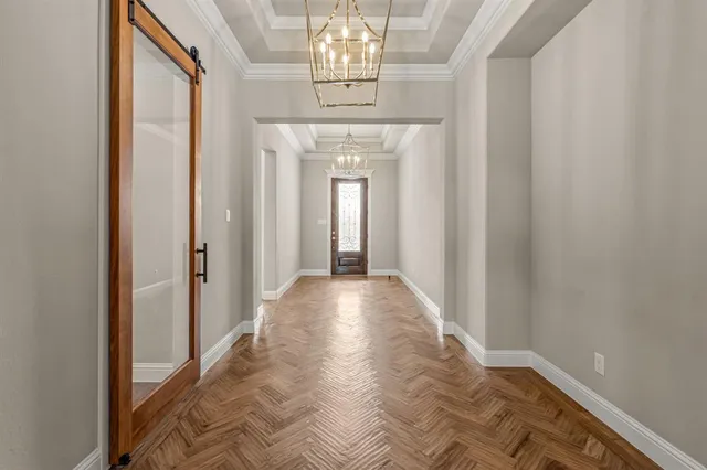 a view of a hallway with a chandelier