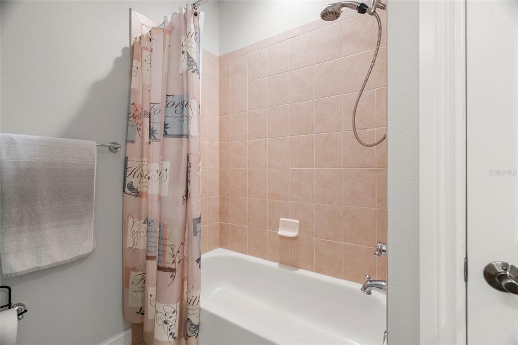1342 Ribolla Drive Palm Harbor, FL 34683 - Photo 15 of 37 a bathroom with a bath tub and shower