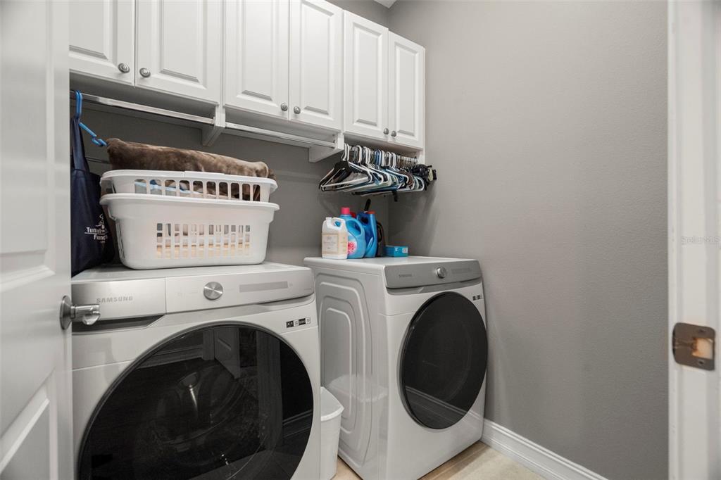 1342 Ribolla Drive Palm Harbor, FL 34683 - Photo 28 of 37 a view of washer and dryer with kitchen in the background