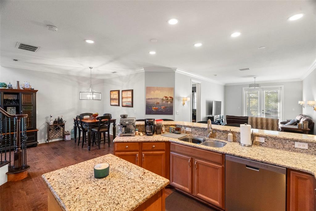 1342 Ribolla Drive Palm Harbor, FL 34683 - Photo 9 of 37 a kitchen with lots of counter top space and dining table