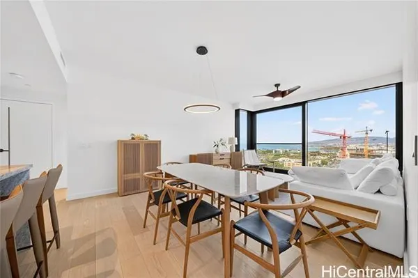 a dining room with furniture and a floor to ceiling window
