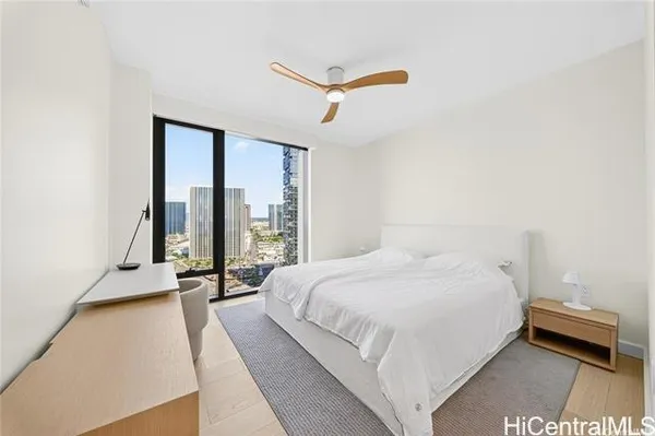 a bedroom with a bed and a large window