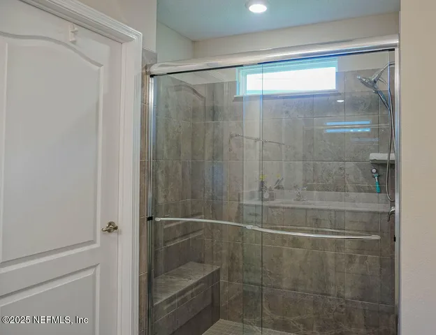 a bathroom with a glass shower door