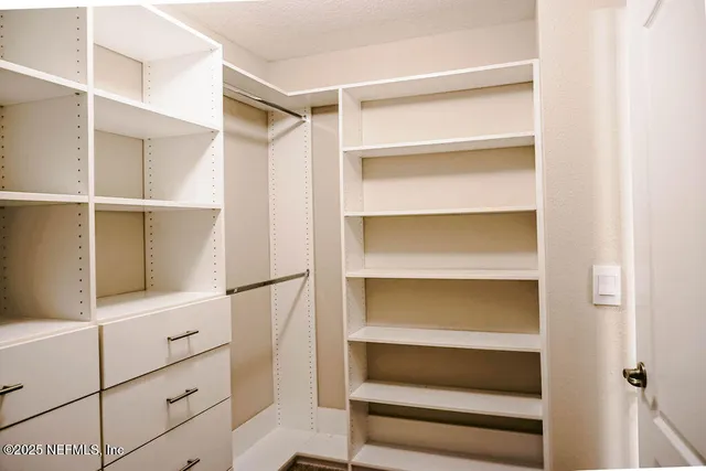 a view of an empty walk in closet