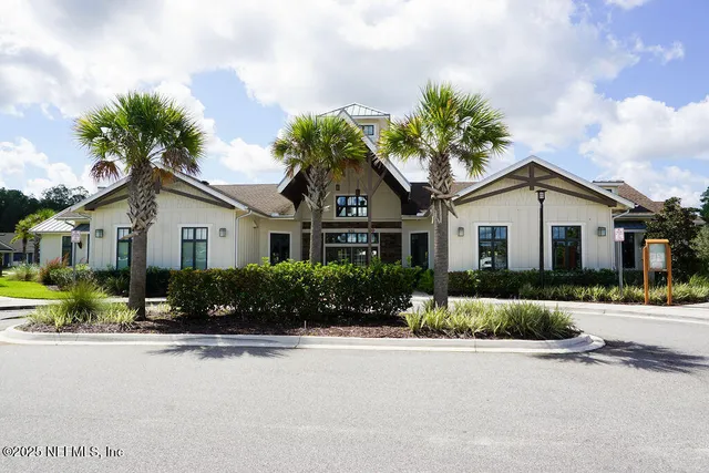a front view of a house with a yard and outdoor seating