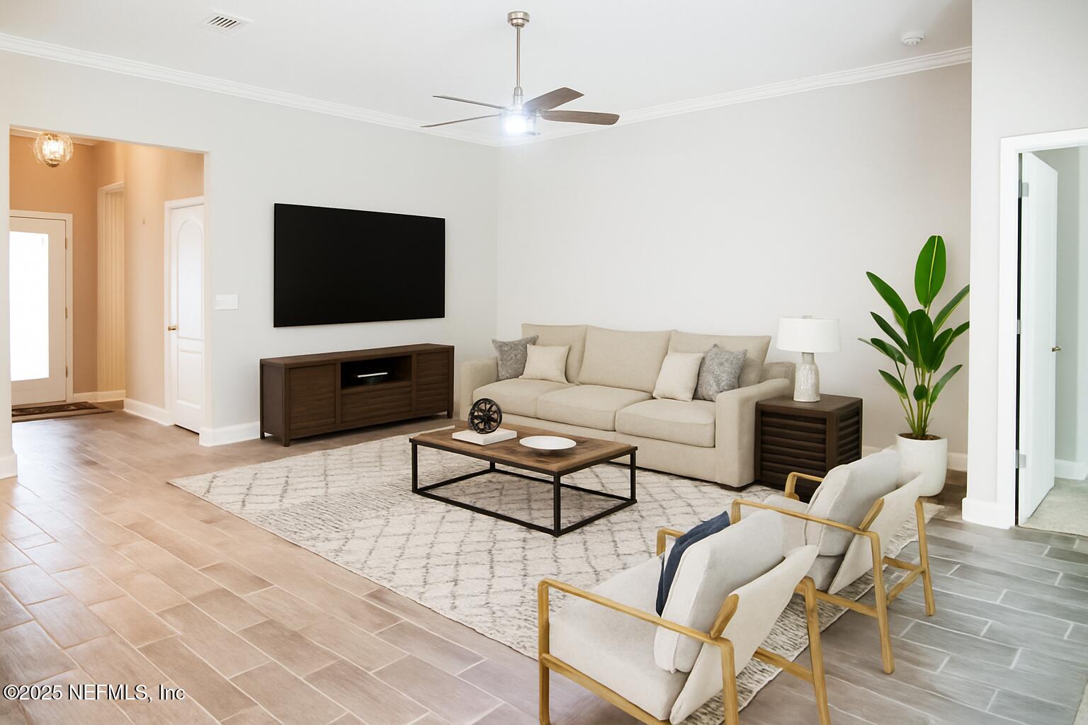 114 Eagles Landing Ln Street St. Augustine, FL 32095 - Photo 8 of 21 a living room with furniture a flat screen tv and a window