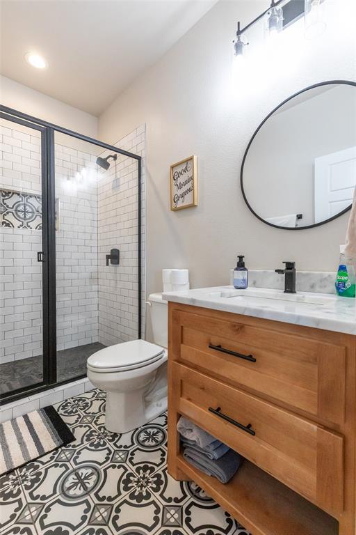 296 Mesquite Ridge Lane Lawn, TX 79530 - Photo 24 of 35 a bathroom with a toilet a sink and a mirror
