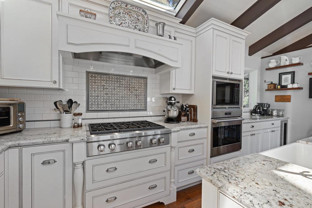 15 Mentone Road Carmel, CA 93923 - Photo 13 of 56 a kitchen with stainless steel appliances granite countertop a stove sink and cabinets