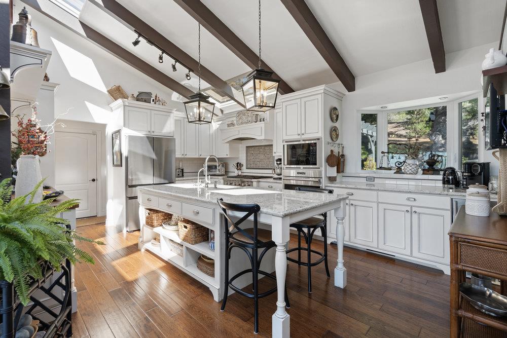 15 Mentone Road Carmel, CA 93923 - Photo 14 of 56 a kitchen with stainless steel appliances kitchen island granite countertop a stove a sink and a refrigerator