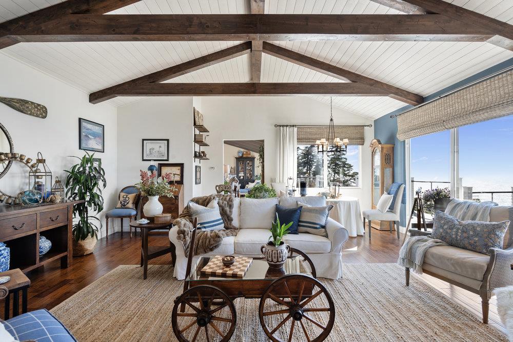 15 Mentone Road Carmel, CA 93923 - Photo 25 of 56 a living room with furniture a fireplace and a floor to ceiling window