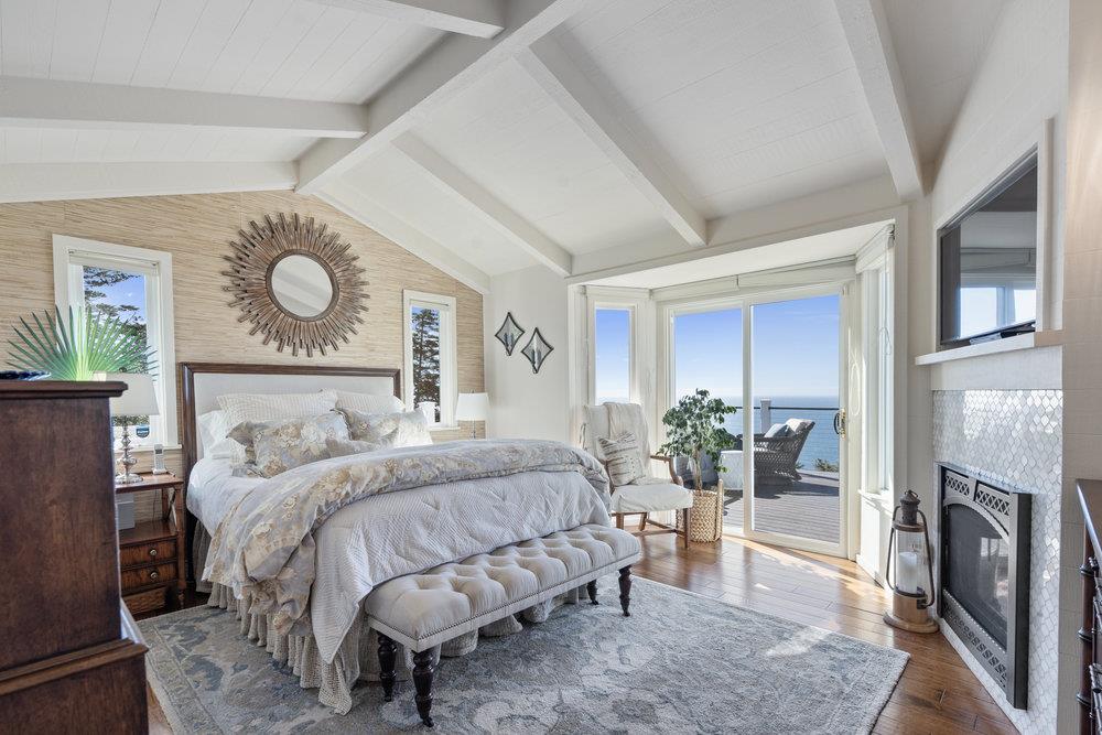 15 Mentone Road Carmel, CA 93923 - Photo 29 of 56 a bedroom with a bed and a fireplace