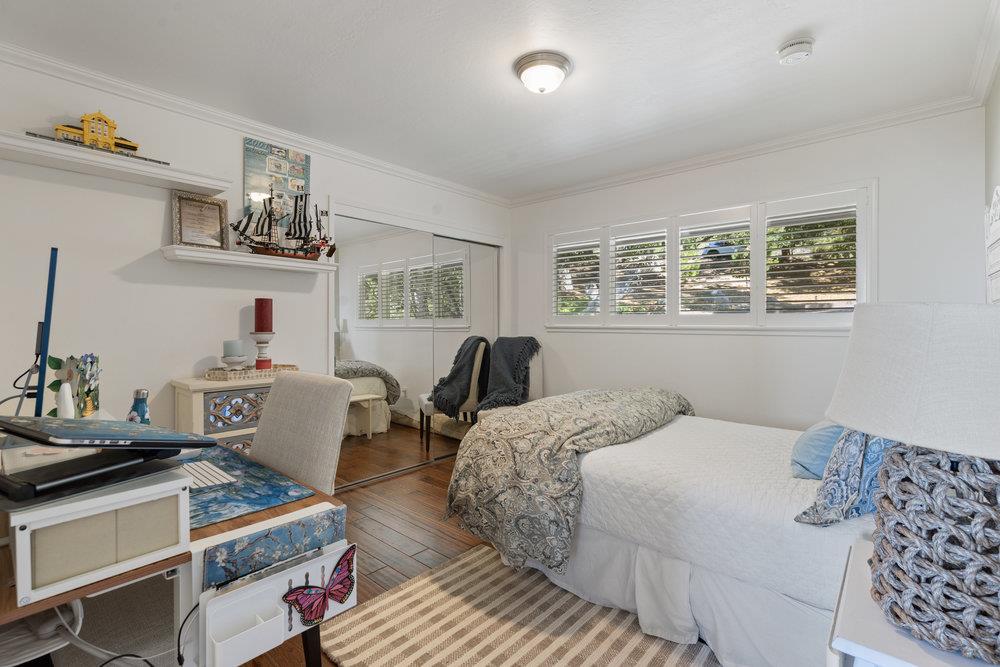 15 Mentone Road Carmel, CA 93923 - Photo 37 of 56 a bedroom with a bed and wooden floor