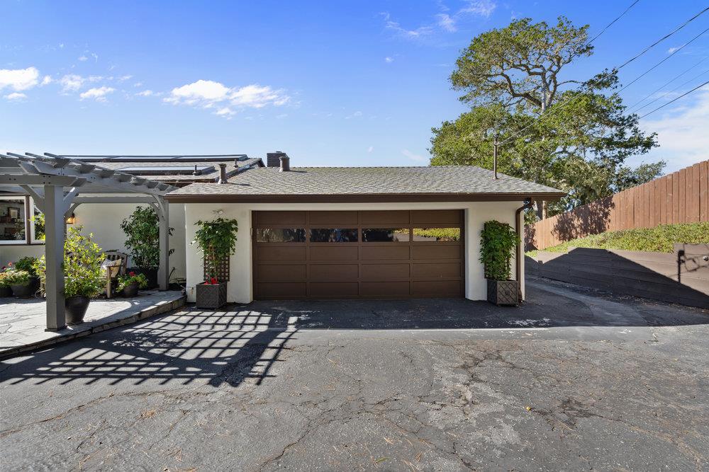 15 Mentone Road Carmel, CA 93923 - Photo 51 of 56 a front view of a house with a yard and garage