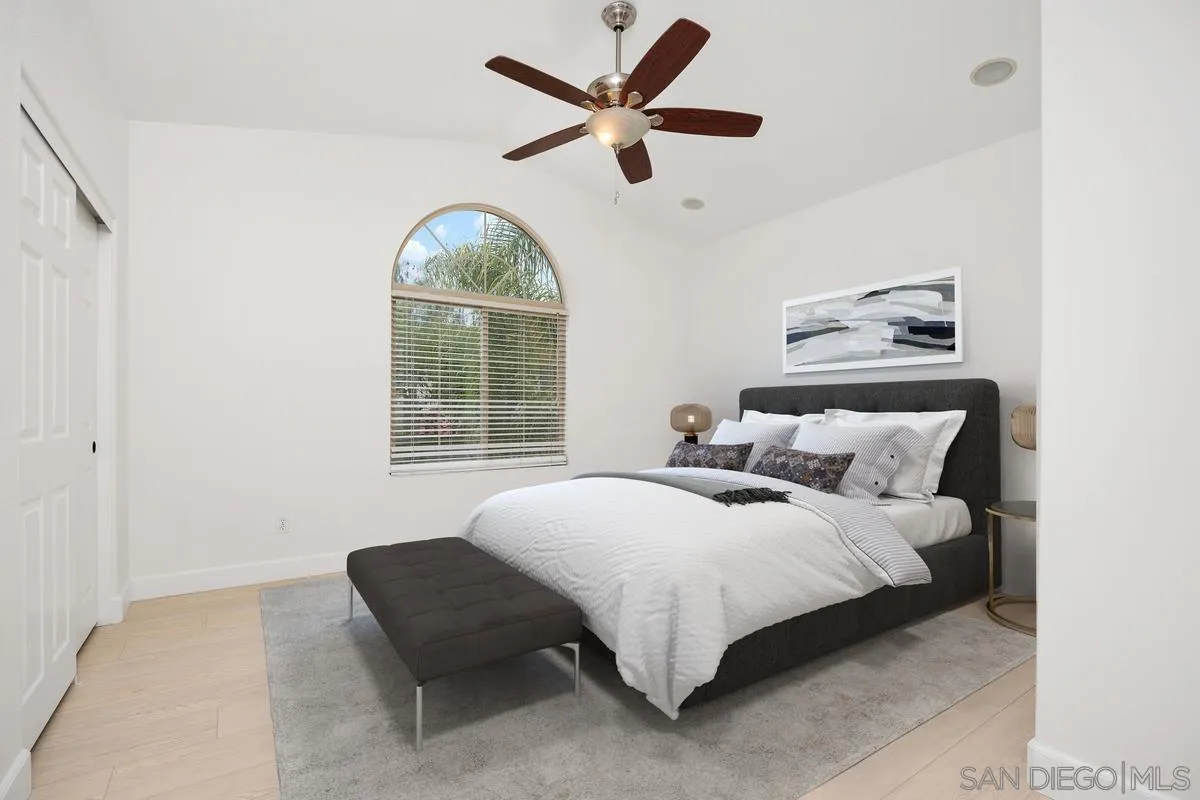 4054 Craven Road, Unit 49 Oceanside, CA 92057 - Photo 17 of 37 a bedroom with bed and a large window