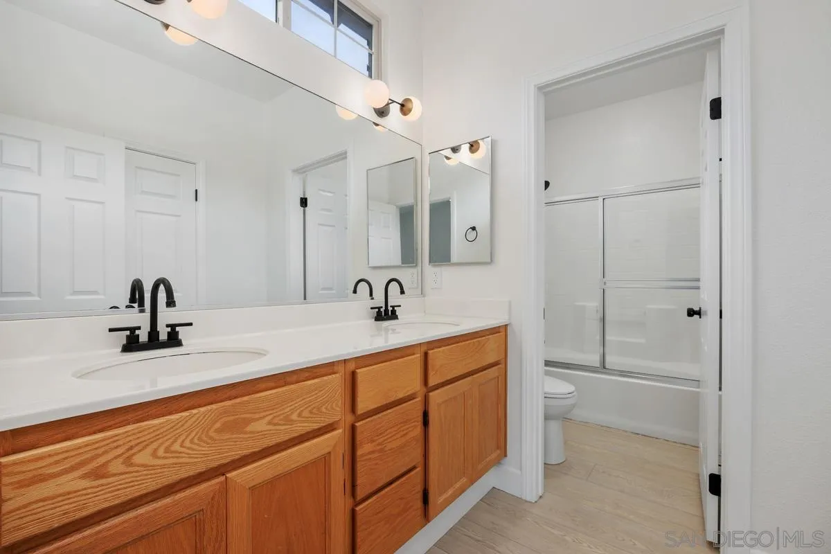 4054 Craven Road, Unit 49 Oceanside, CA 92057 - Photo 21 of 37 a bathroom with a sink and mirror