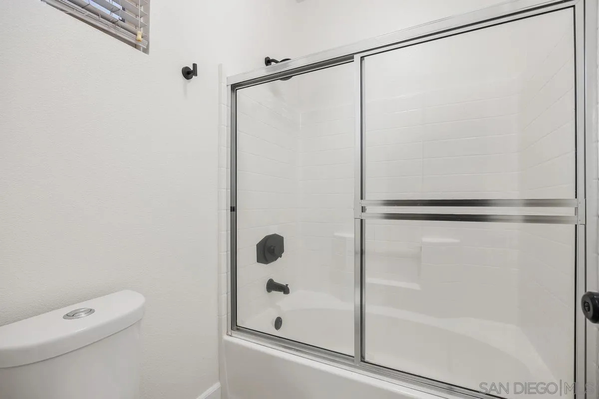 4054 Craven Road, Unit 49 Oceanside, CA 92057 - Photo 22 of 37 a bathroom with a shower a toilet and a window