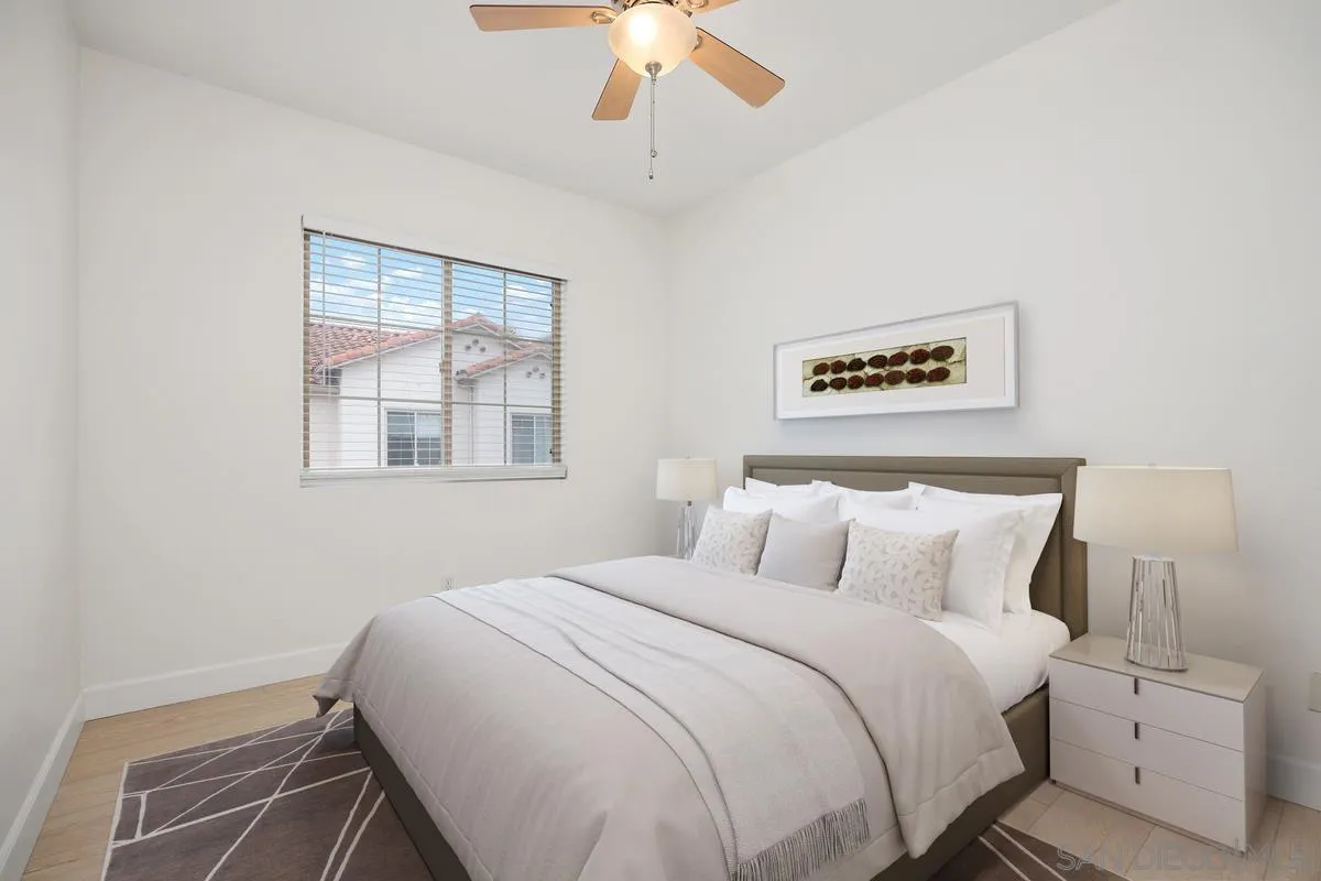 4054 Craven Road, Unit 49 Oceanside, CA 92057 - Photo 25 of 37 a bedroom with a large bed and a chandelier