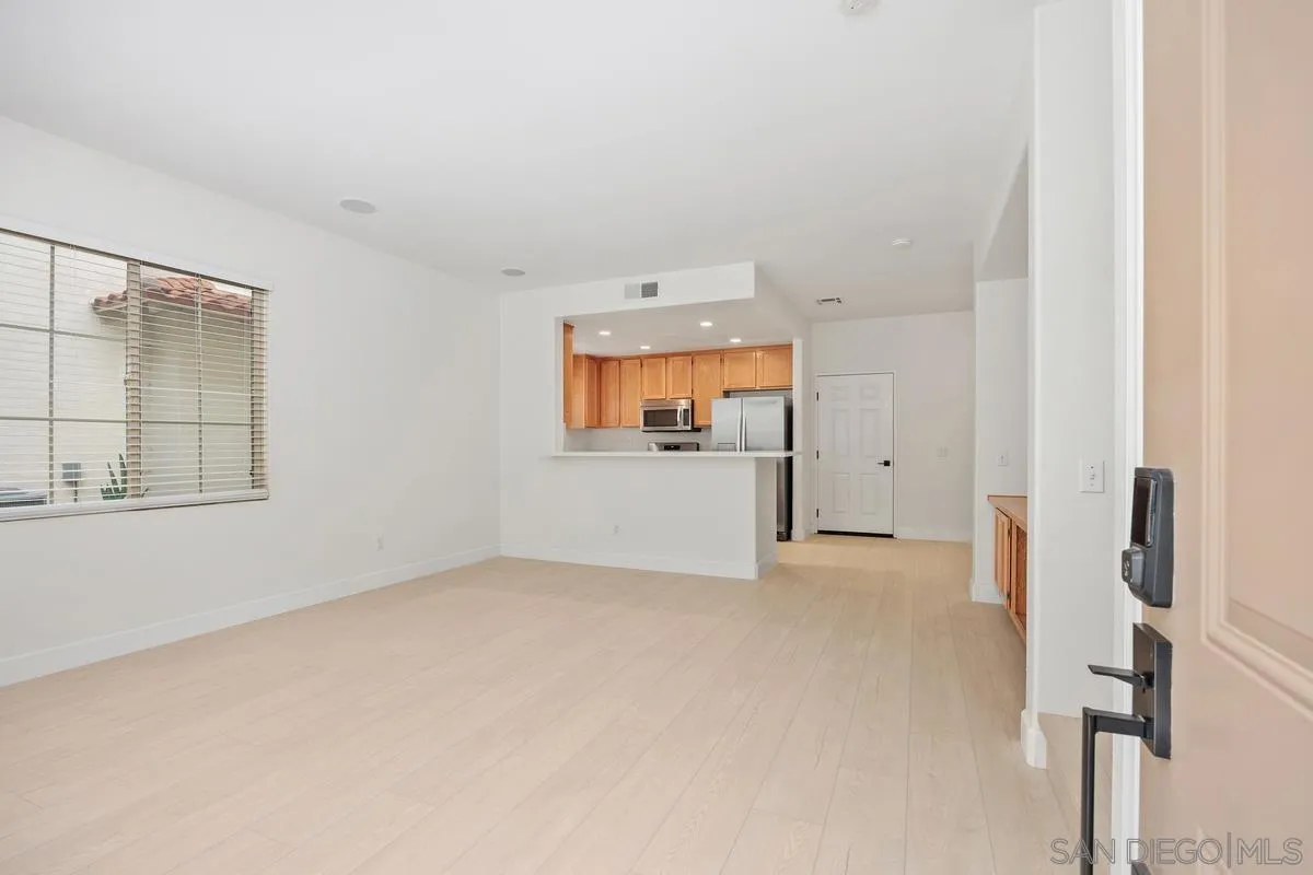 4054 Craven Road, Unit 49 Oceanside, CA 92057 - Photo 9 of 37 an empty room with a fireplace and windows