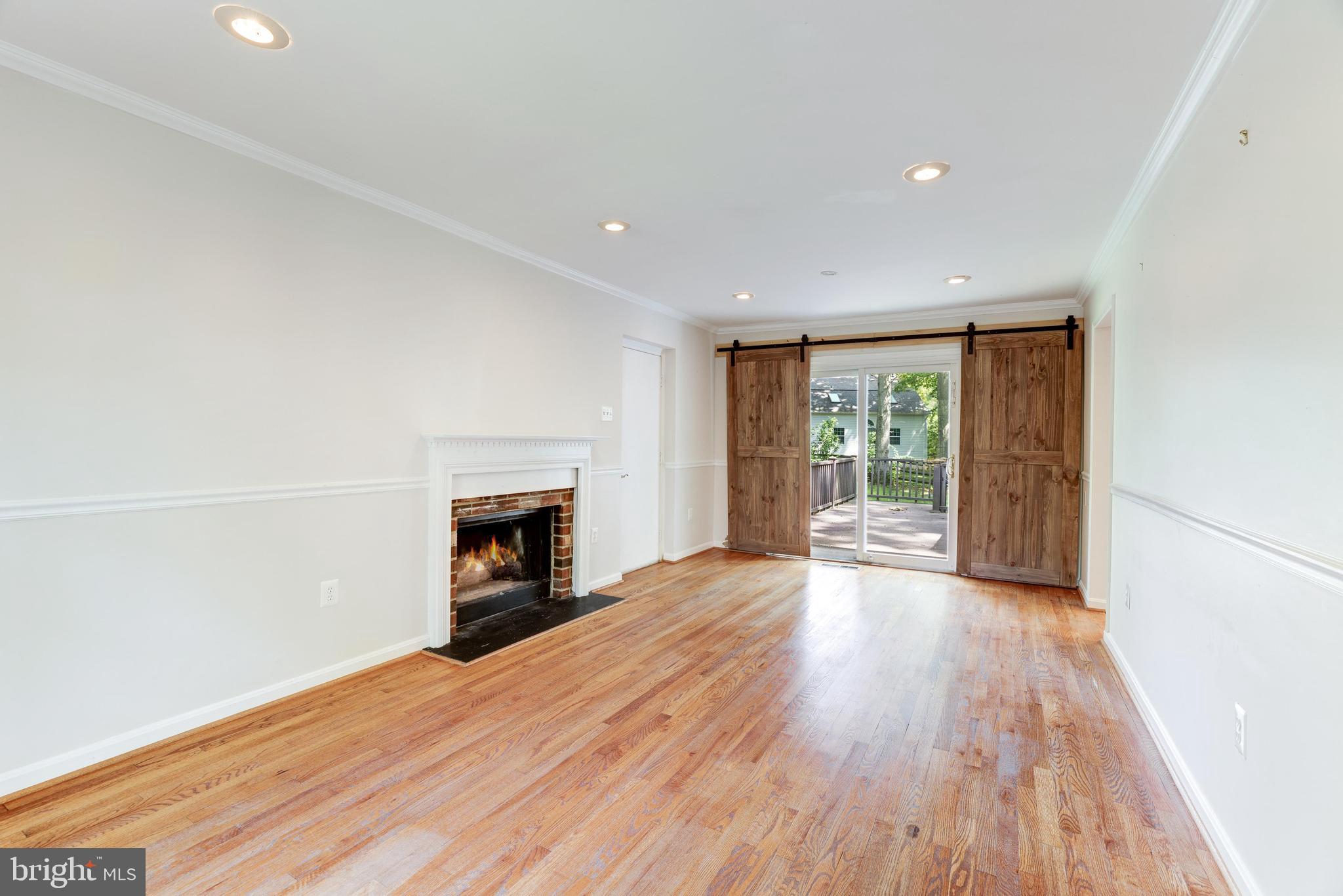 1816 Post Oak Trail Reston, VA 20191 - Photo 24 of 58 Family room with fireplace and barn doors