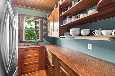 a kitchen with a sink and large window