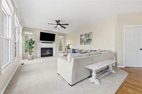 a living room with furniture a fireplace and a flat screen tv