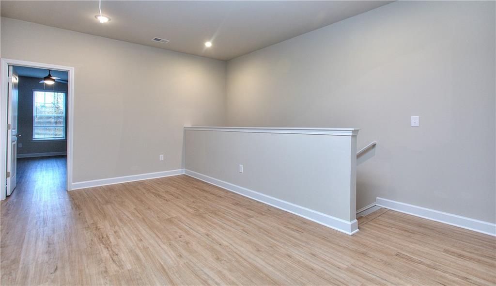 2562 Harbor Ridge Pass, Unit 338 Gainesville, GA 30507 - Photo 13 of 21 wooden floor in an empty room with a window