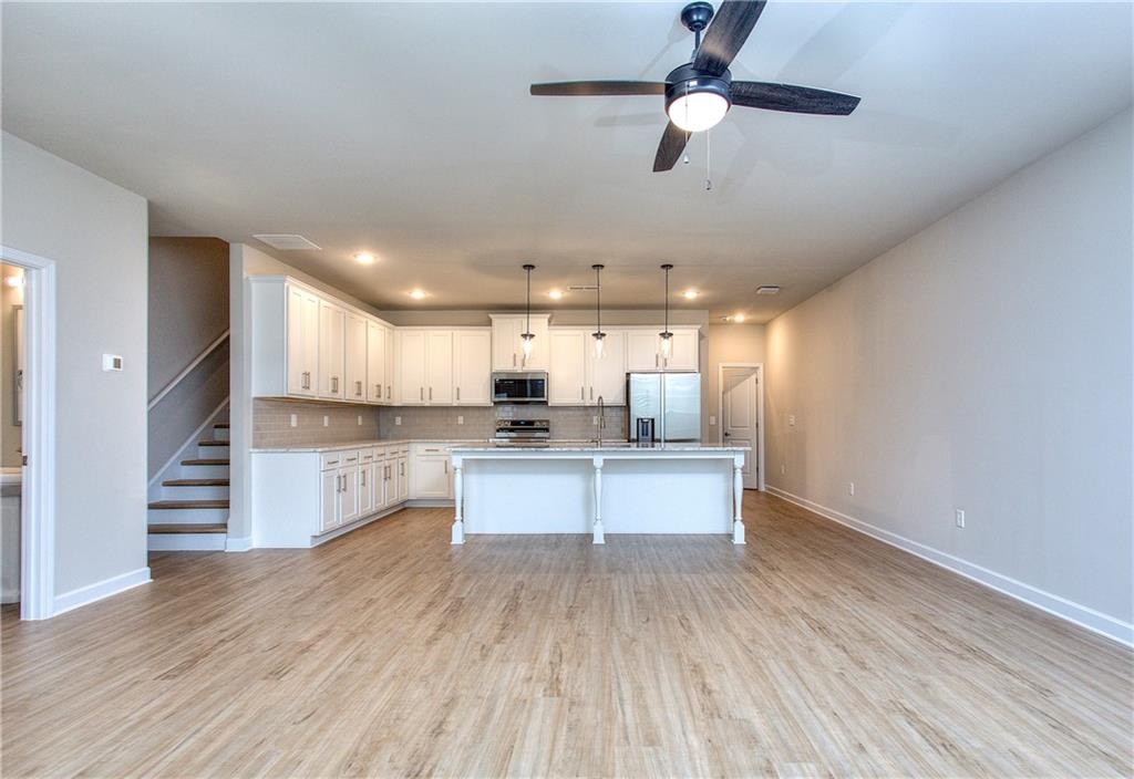 2562 Harbor Ridge Pass, Unit 338 Gainesville, GA 30507 - Photo 2 of 21 a kitchen with stainless steel appliances kitchen island hardwood floor sink and stove