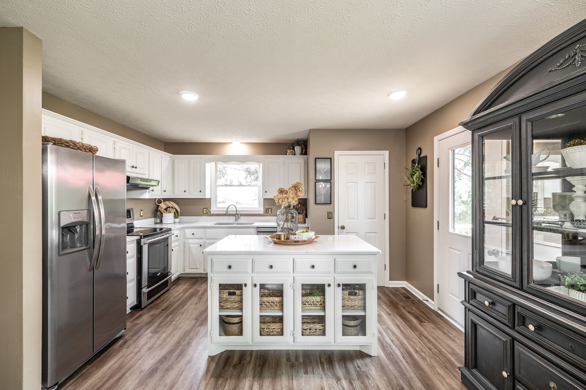 405 Timberlake Drive Springfield, TN 37172 - Photo 18 of 46 a kitchen with stainless steel appliances granite countertop a stove top oven a sink dishwasher a dining table and chairs with wooden floor