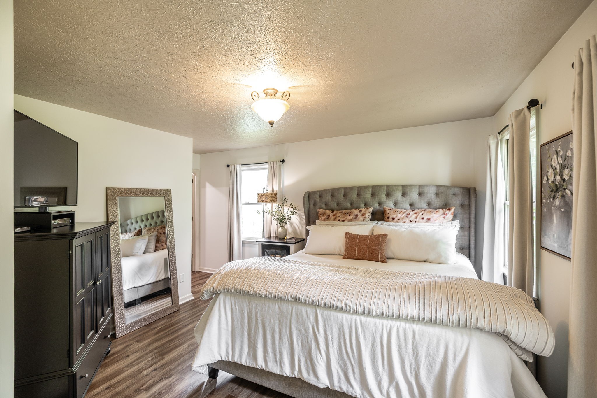 405 Timberlake Drive Springfield, TN 37172 - Photo 26 of 46 a bedroom with a large bed and a chandelier