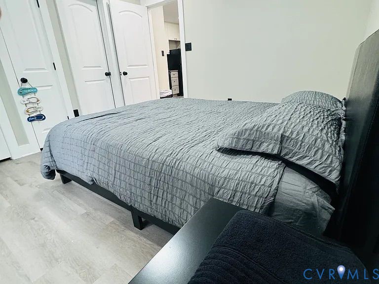 350 Staten Street Norfolk, VA 23503 - Photo 8 of 12 a bedroom with a bed and a mirror