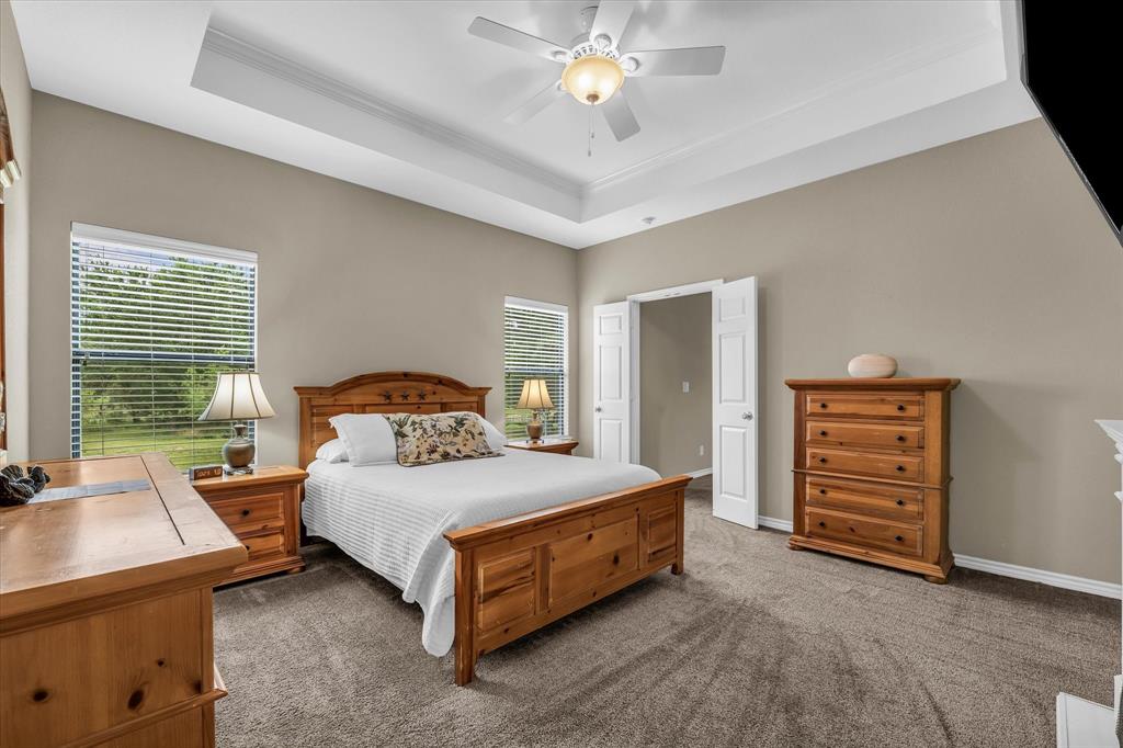613 Bone Road Valley Mills, TX 76689 - Photo 20 of 40 a bedroom with a bed and a chandelier