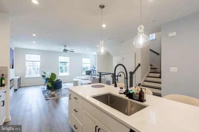 a kitchen with sink refrigerator and window
