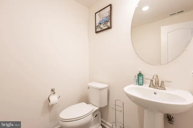 a bathroom with a sink a mirror and a toilet