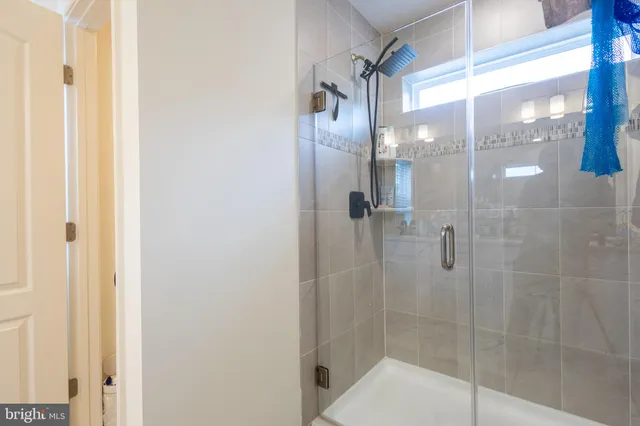 a bathroom with a glass shower door