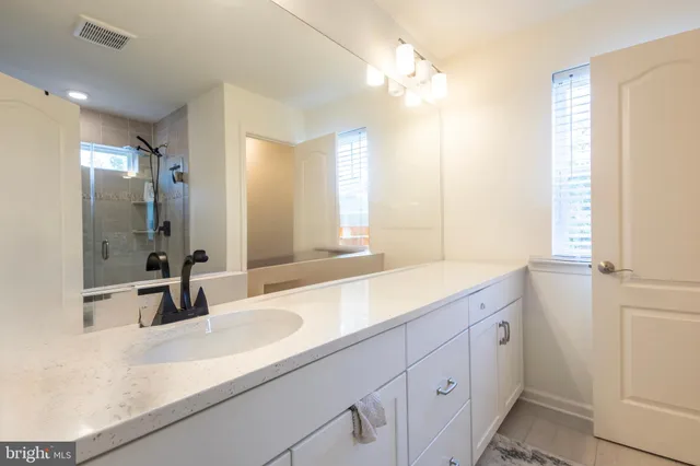 a bathroom with a sink double vanity and a mirror