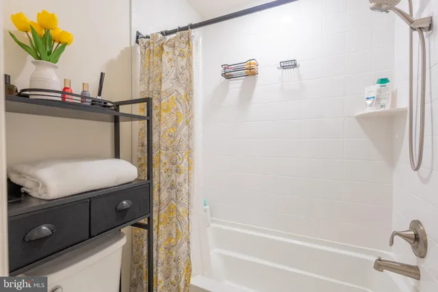 a bathroom with a granite countertop sink a toilet and shower