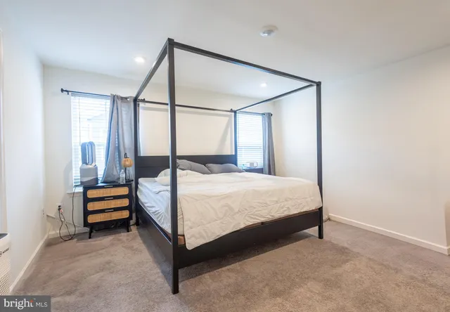 a bed room with a bed and a chair