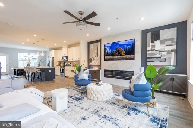 a living room with furniture a fireplace and a flat screen tv