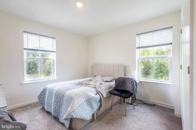 a bed sitting in a bedroom next to a window